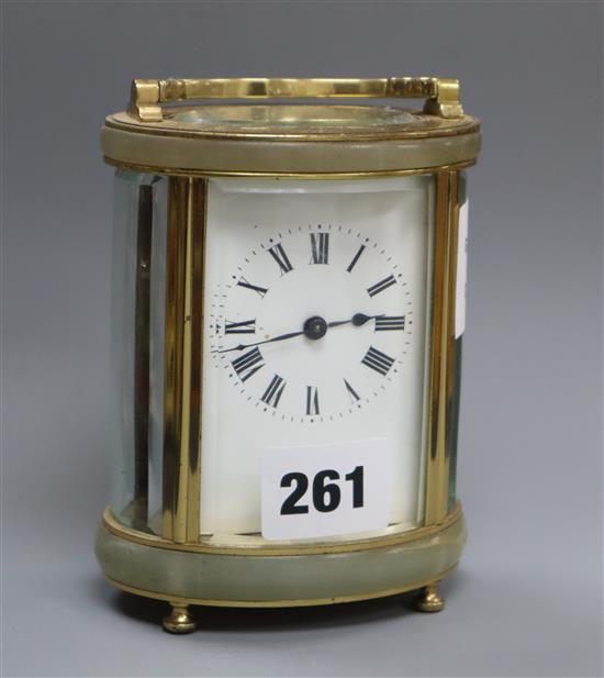 An oval brass carriage timepiece